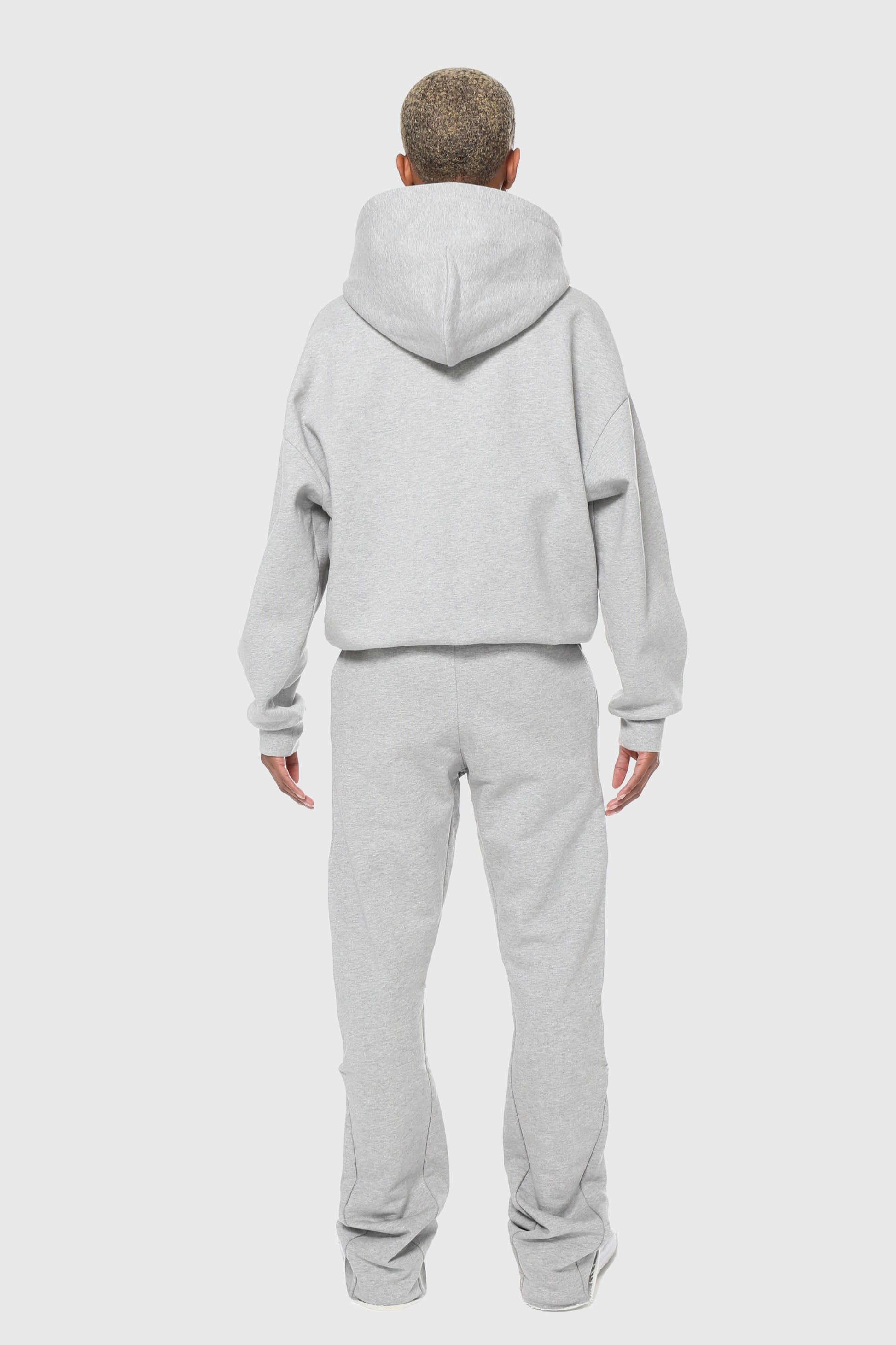 Unisex zip-up hoodie in pure grey, made from 100% organic cotton with a minimalist design, featuring durable double Riri zippers for added functionality and style. Crafted in Britain for a sustainable, premium look, perfect for streetwear styling and versatile enough to pair with both casual and elevated outfits.